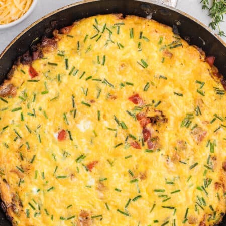 Bacon and Gouda Frittata - This breakfast/brunch recipe is a sophisticated twist on traditional bacon and eggs! Including gouda, chives and shallots, these elegant ingredients make this quick and easy meal seems like a special occasion.
