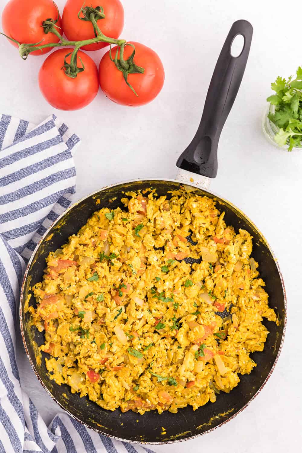 Indian Scrambled Eggs - Bring Indian seasonings to the breakfast table! This quick morning staple is packed with cumin, onion, green chiles, tomatoes, turmeric, and cilantro.