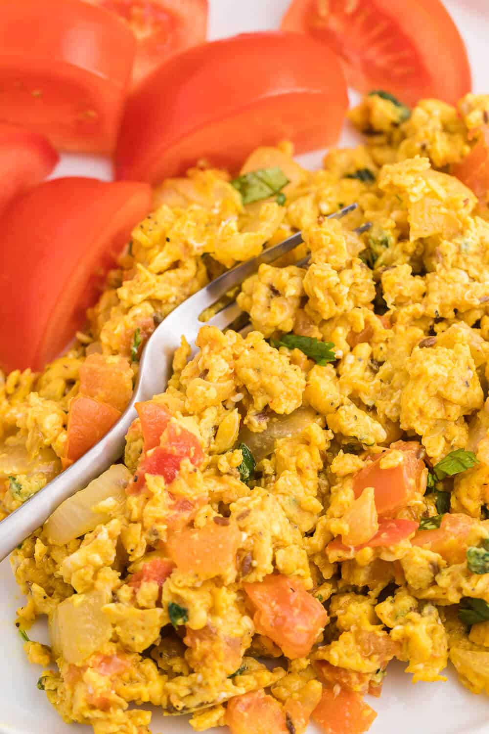 Indian Scrambled Eggs - Bring Indian seasonings to the breakfast table! This quick morning staple is packed with cumin, onion, green chiles, tomatoes, turmeric, and cilantro.