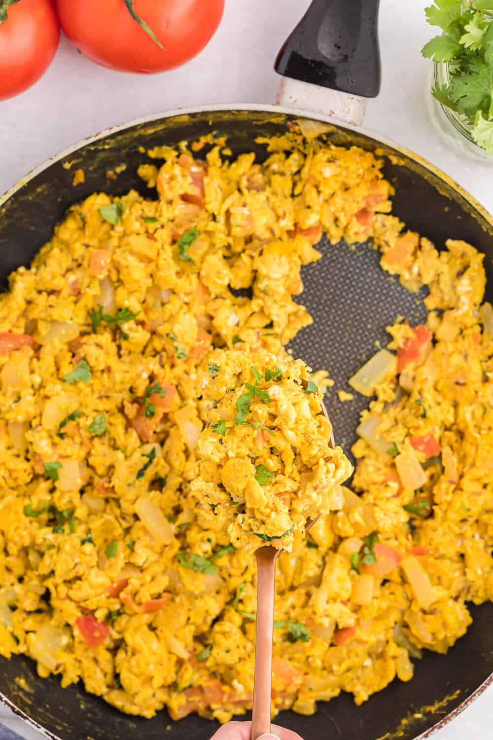 Indian Scrambled Eggs - Bring Indian seasonings to the breakfast table! This quick morning staple is packed with cumin, onion, green chiles, tomatoes, turmeric, and cilantro.