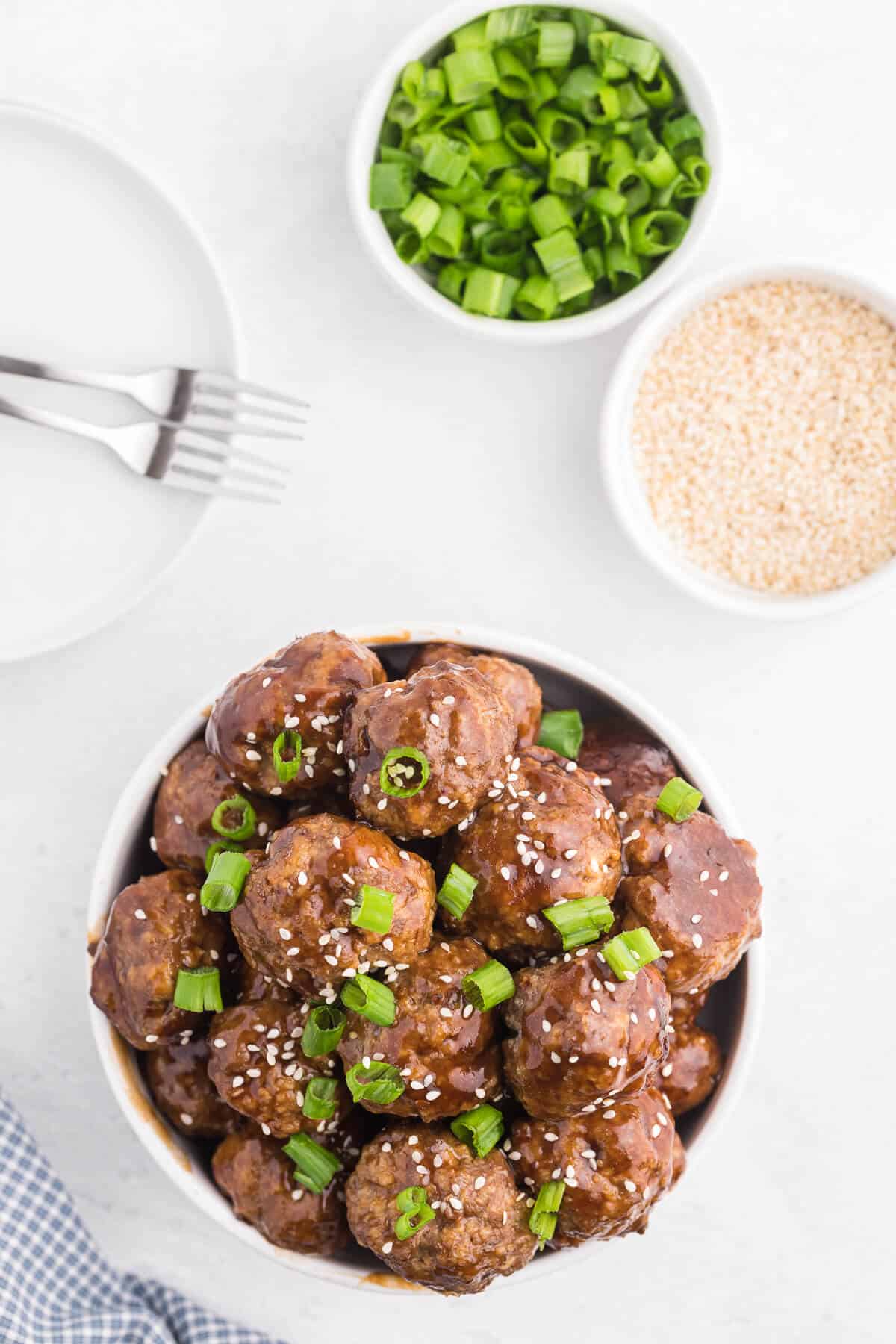 Ginger Meatballs - Add this Asian meatball recipe to your next party menu! Homemade beef meatballs with zesty ginger are smothered in sweet and tangy stir fry sauce. Yum!