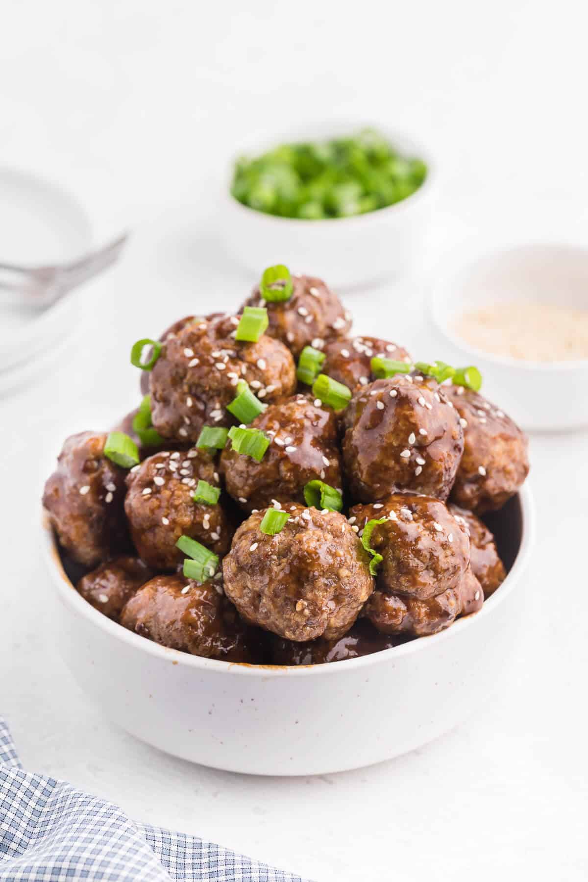Ginger Meatballs - Add this Asian meatball recipe to your next party menu! Homemade beef meatballs with zesty ginger are smothered in sweet and tangy stir fry sauce. Yum!