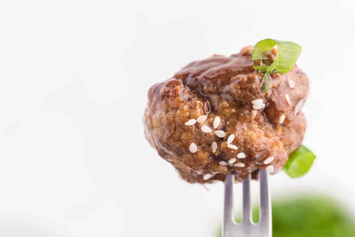 Ginger Meatballs - Add this Asian meatball recipe to your next party menu! Homemade beef meatballs with zesty ginger are smothered in sweet and tangy stir fry sauce. Yum!