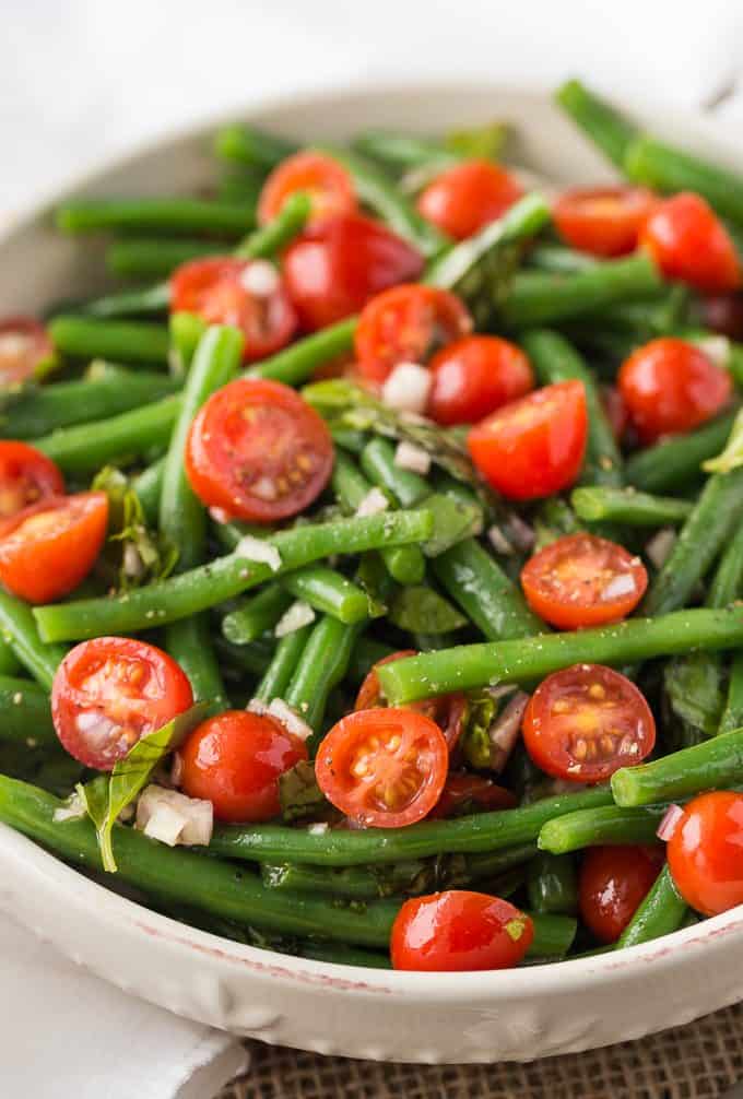 Green Bean and Tomato Salad - An effortless side dish that screams summer! This light and crispy side dish is great for weeknight dinners or your next barbecue.