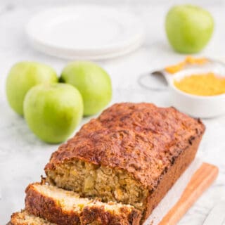 A loaf of apple cheddar bread with slices cut on the end