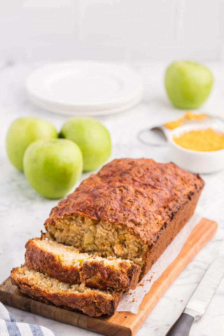 A loaf of apple cheddar bread with slices cut on the end