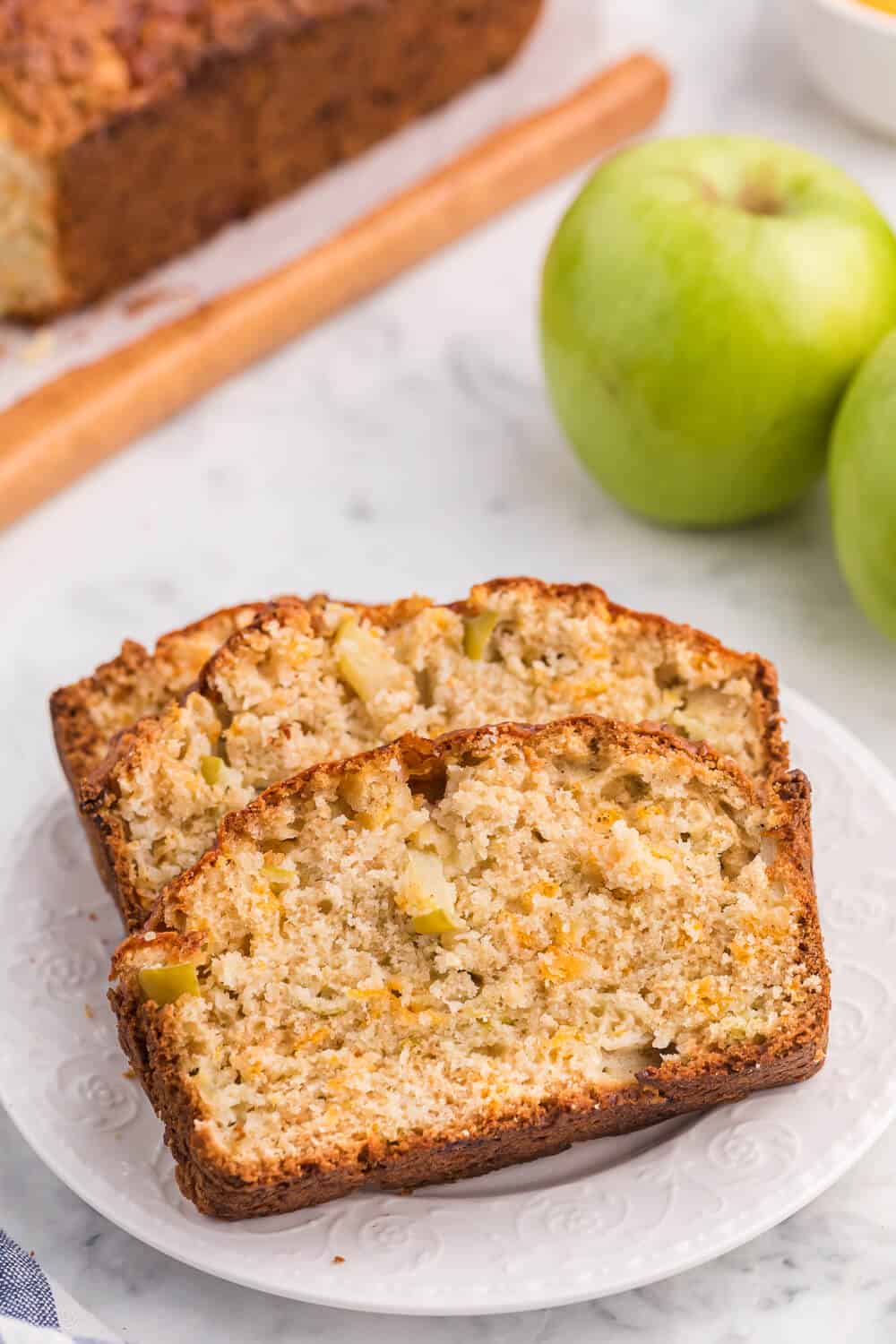 Slices of apple cheddar bread on a white plate