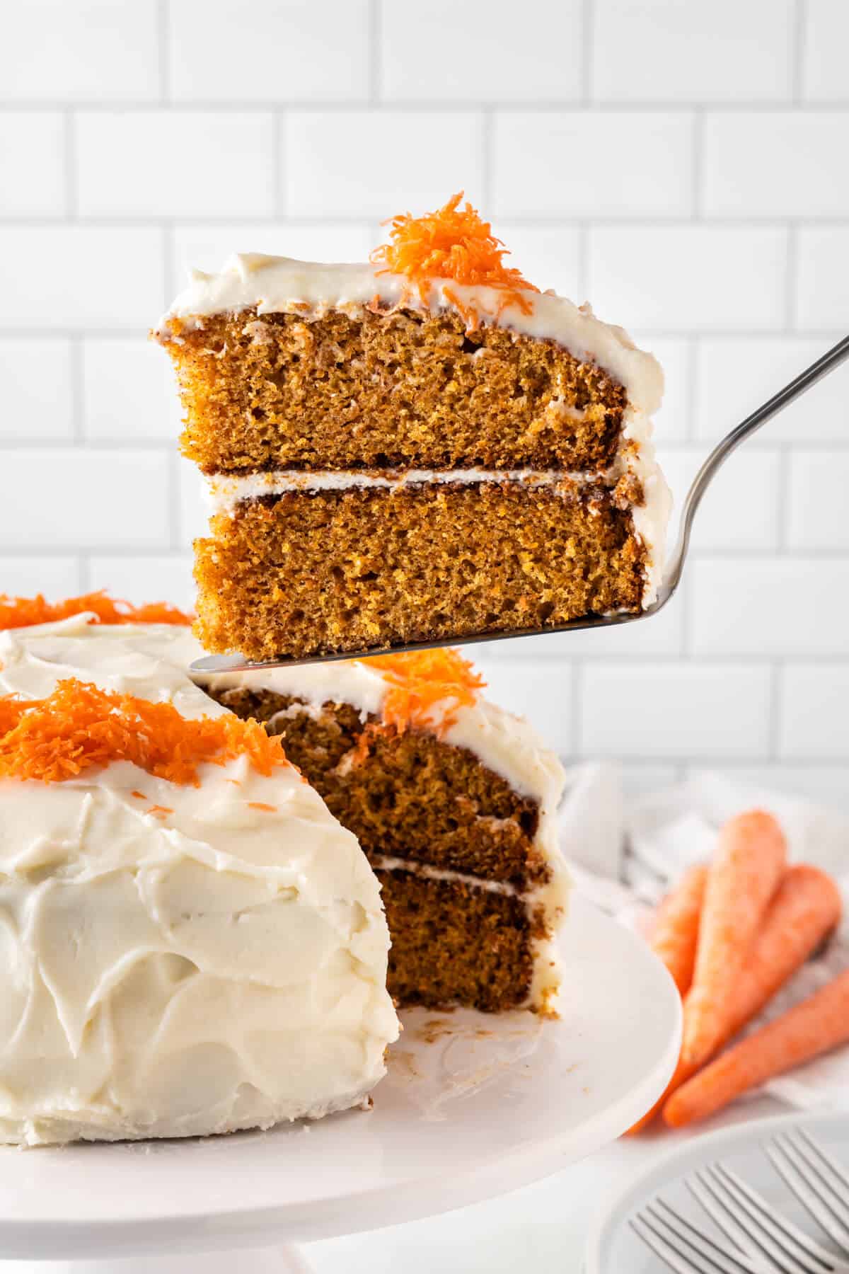 A slice of carrot cake on a serving spatula.