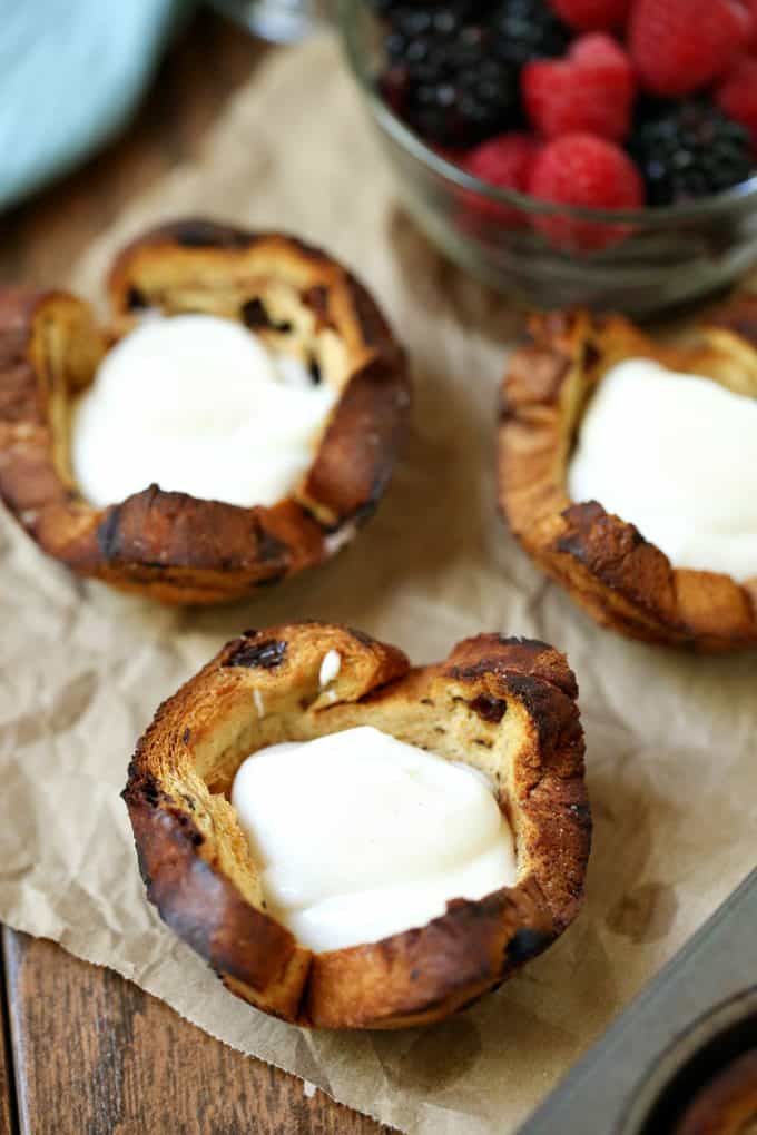 Mixed Berry Breakfast Cups - With a swirl of cinnamon and sweet raisins, these adorable little breakfast cups are begging to be filled as you wish! Try them filled with yogurt and mixed berries - yum!