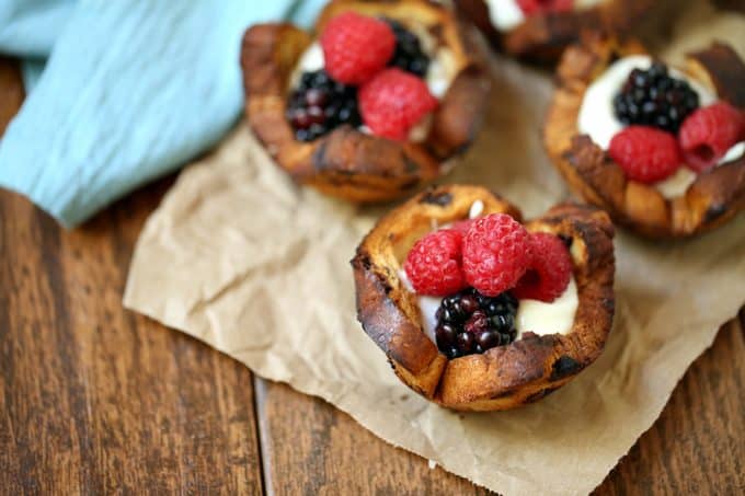 Mixed Berry Breakfast Cups - With a swirl of cinnamon and sweet raisins, these adorable little breakfast cups are begging to be filled as you wish! Try them filled with yogurt and mixed berries - yum!