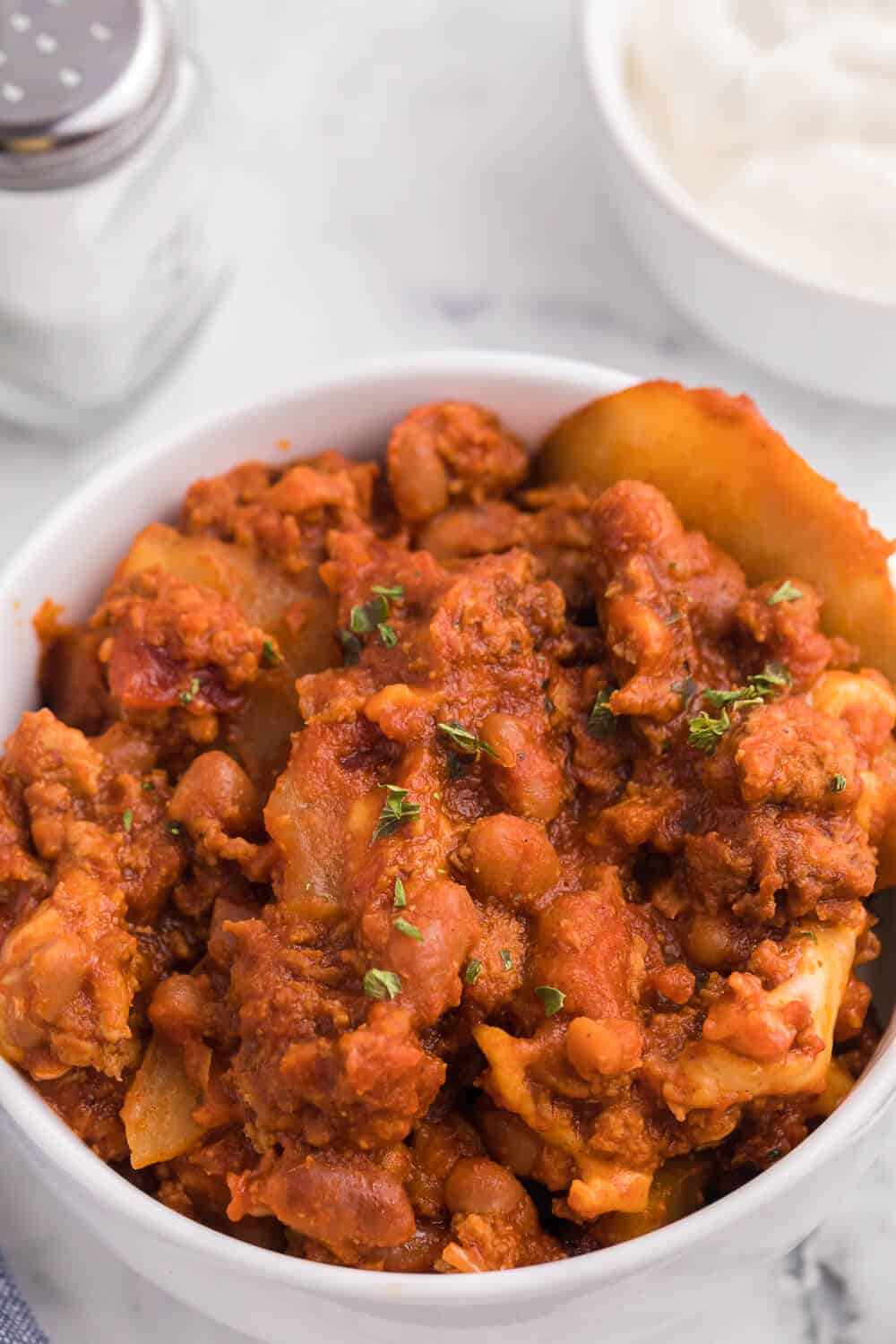 Cowboy Chicken Chili Casserole - Layers of chili, beans and potatoes for a hearty meal made in the slow cooker!