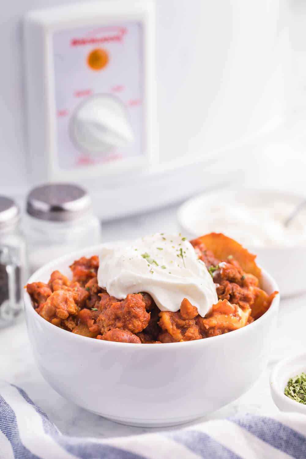 Cowboy Chicken Chili Casserole - Layers of chili, beans and potatoes for a hearty meal made in the slow cooker!