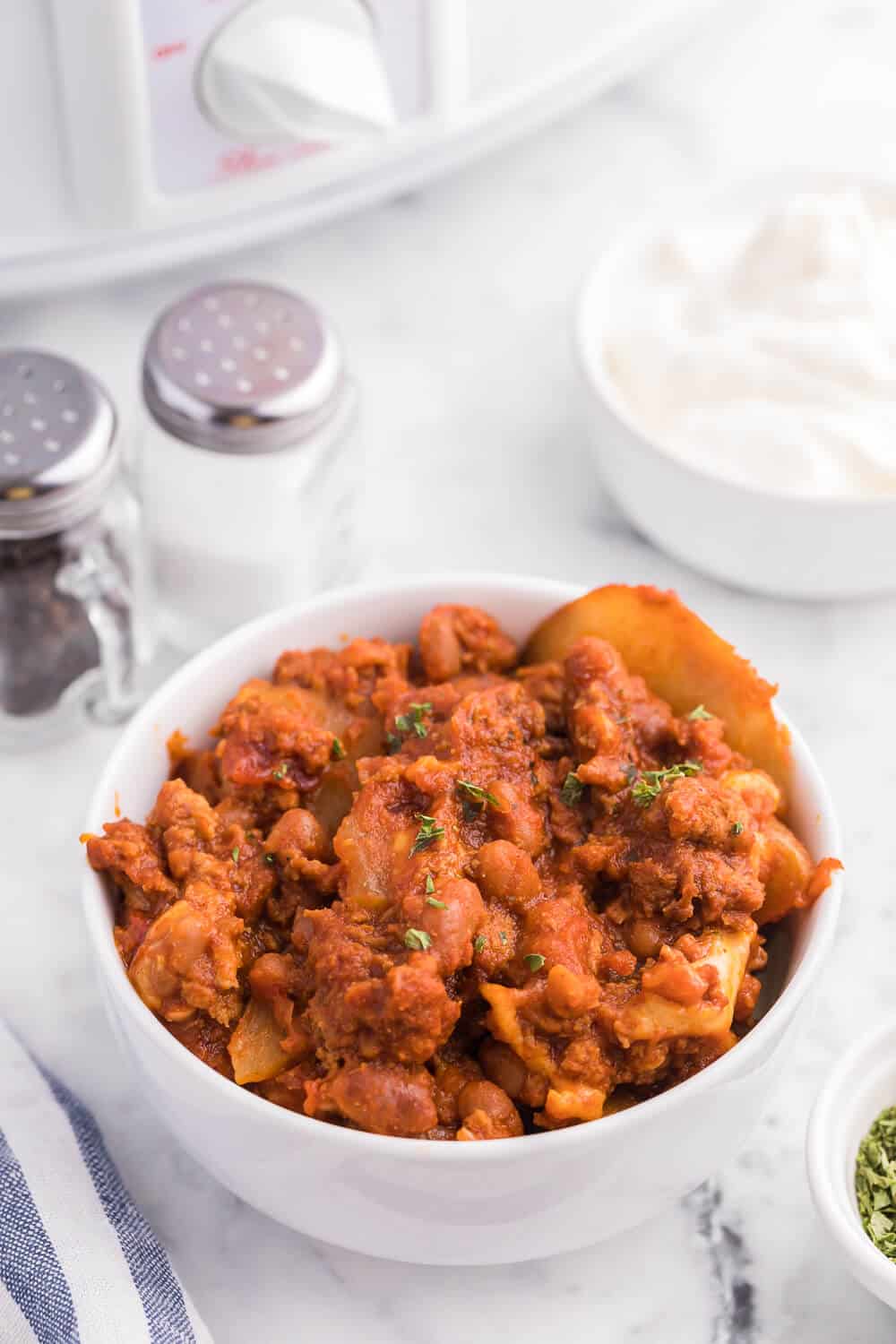 Cowboy Chicken Chili Casserole - Layers of chili, beans and potatoes for a hearty meal made in the slow cooker!