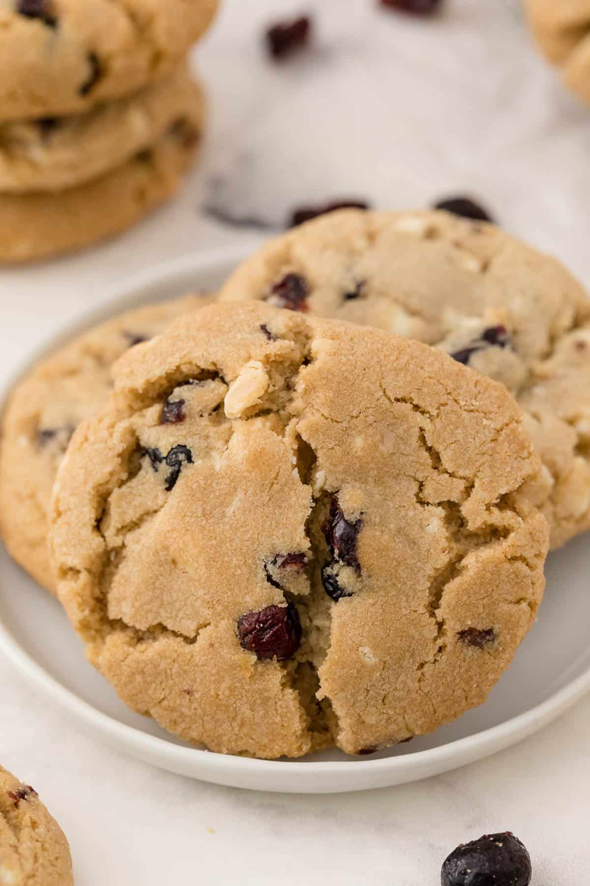 a plate of white chocolate chunk cranberry cookies