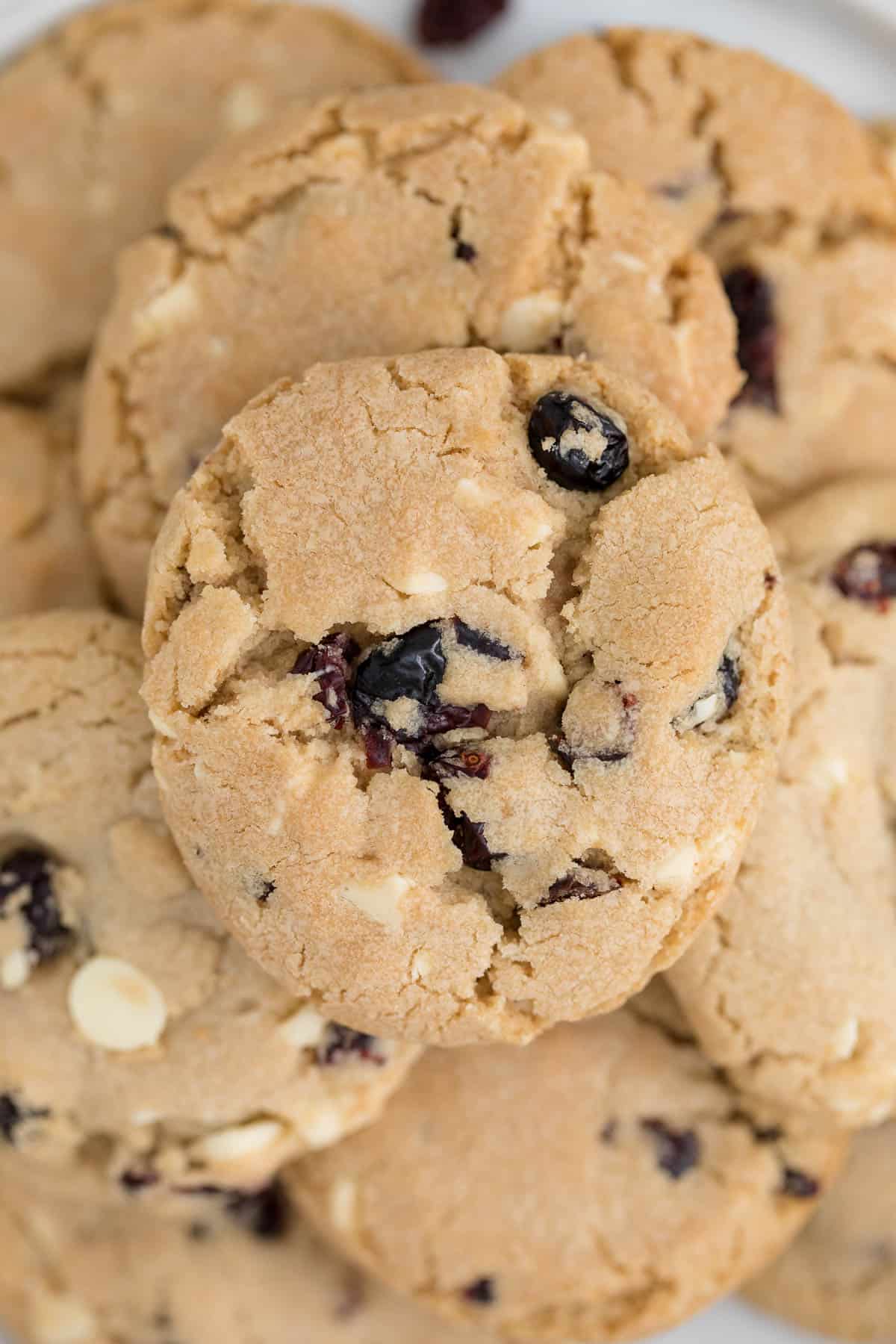 a group of white chocolate chunk cranberry cookies on plate