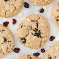 white chocolate chunk cranberry cookies on parchment paper