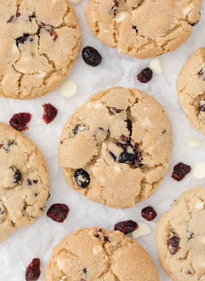 white chocolate chunk cranberry cookies on parchment paper