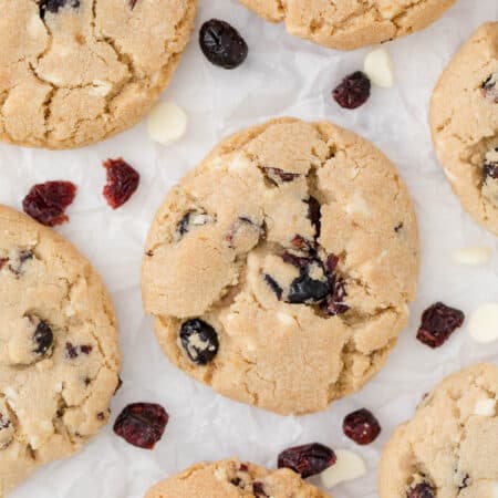 white chocolate chunk cranberry cookies on parchment paper