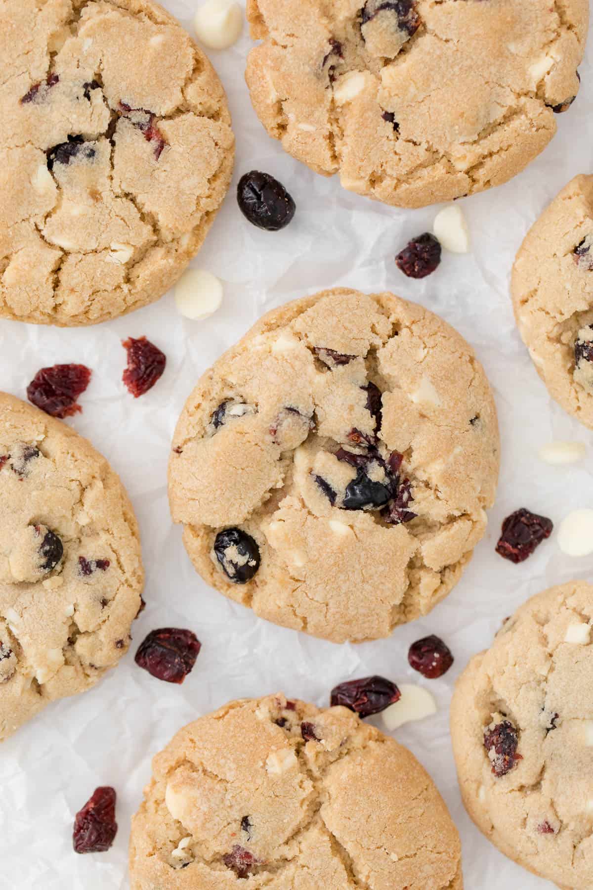 white chocolate chunk cranberry cookies on parchment paper