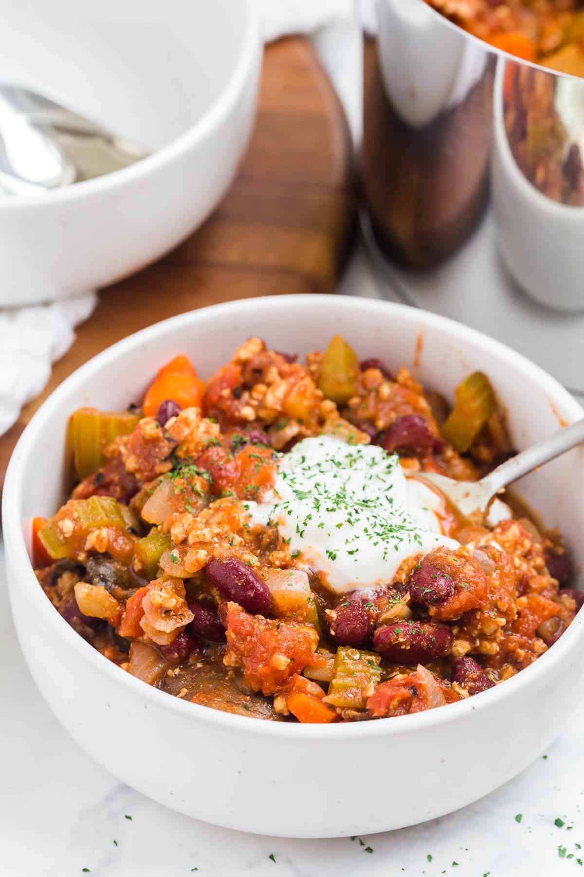 Chicken chili in a bowl with a spoon.