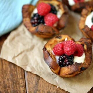 Mixed Berry Breakfast Cups - With a swirl of cinnamon and sweet raisins, these adorable little breakfast cups are begging to be filled as you wish! Try them filled with yogurt and mixed berries – yum!