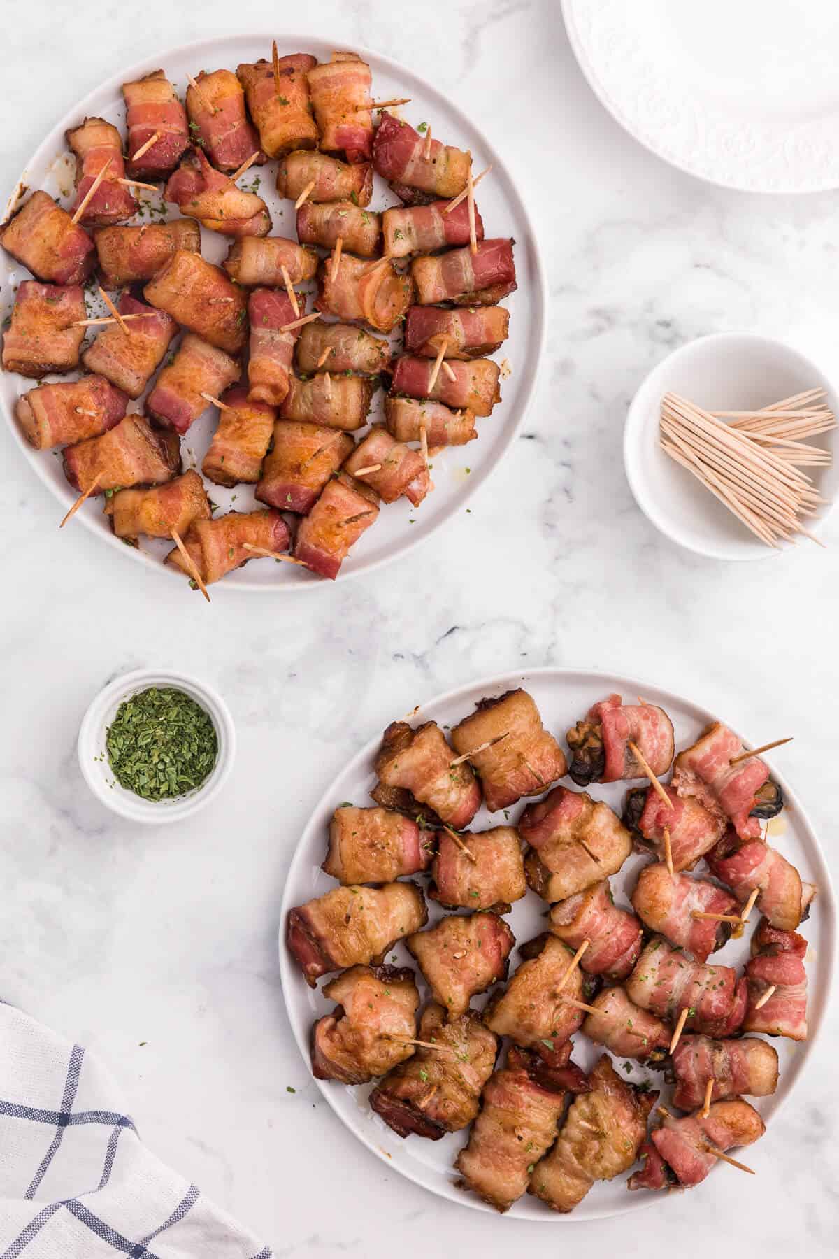 Bacon Wrapped Appetizers - Bite sized and addicting! Try four varieties - bacon wrapped water chestnuts, bacon wrapped smoked oysters, bacon wrapped pineapple and bacon wrapped olives.