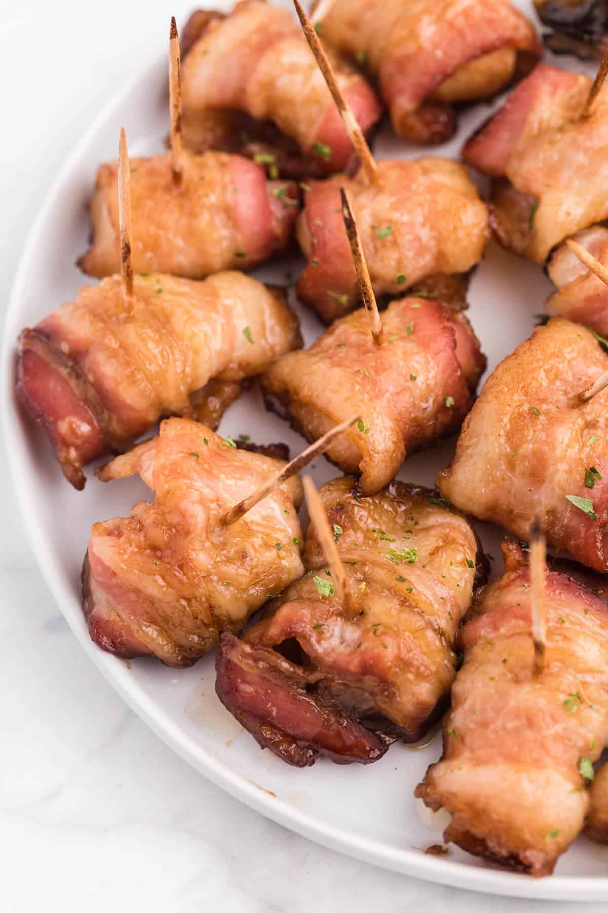 Bacon Wrapped Appetizers - Bite sized and addicting! Try four varieties - bacon wrapped water chestnuts, bacon wrapped smoked oysters, bacon wrapped pineapple and bacon wrapped olives.