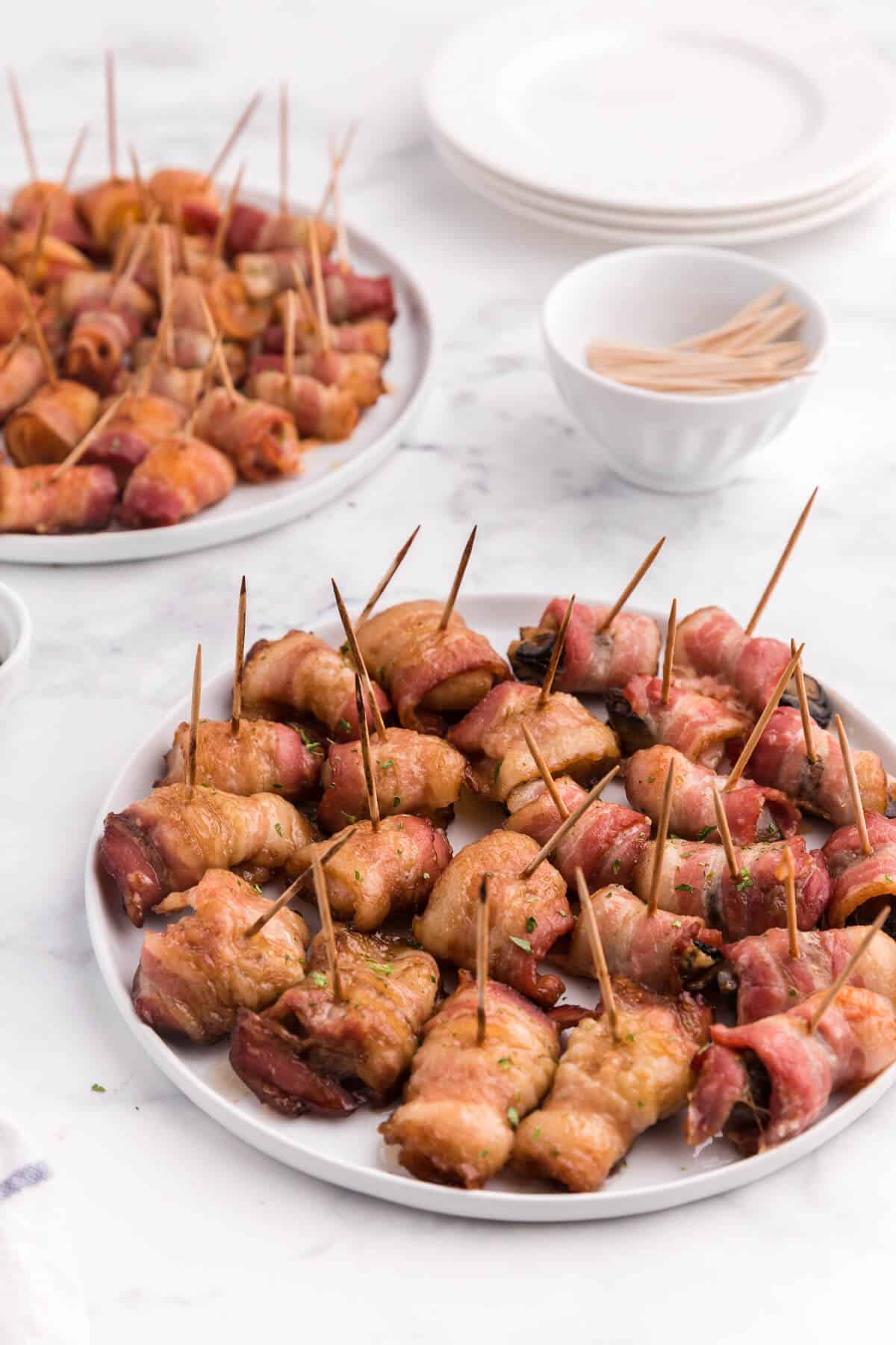 Bacon Wrapped Appetizers - Bite sized and addicting! Try four varieties - bacon wrapped water chestnuts, bacon wrapped smoked oysters, bacon wrapped pineapple and bacon wrapped olives.