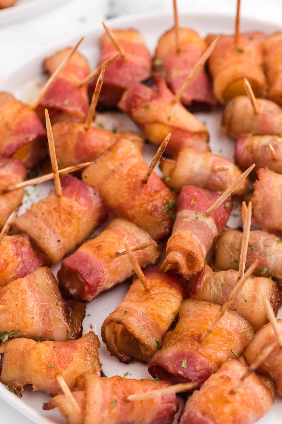 Bacon Wrapped Appetizers - Bite sized and addicting! Try four varieties - bacon wrapped water chestnuts, bacon wrapped smoked oysters, bacon wrapped pineapple and bacon wrapped olives.