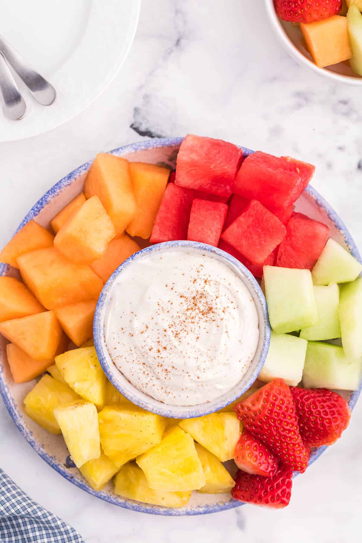 Cinnamon Cream Cheese Dip - Only four ingredients in this simple fruit dip. It's super easy to whip up and can be made the night before and kept in the fridge. Try with fruit, cookies or sweet crackers.