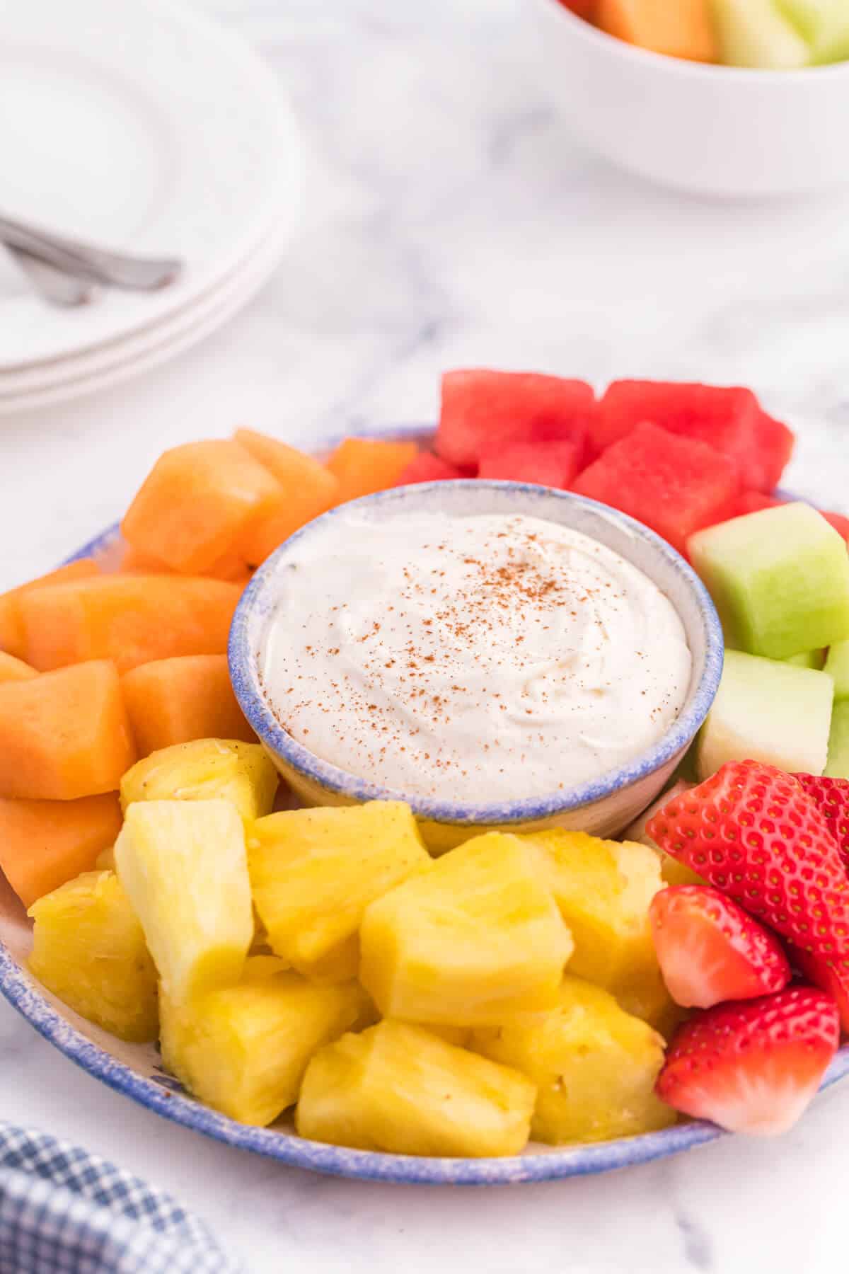 Cinnamon Cream Cheese Dip - Only four ingredients in this simple fruit dip. It's super easy to whip up and can be made the night before and kept in the fridge. Try with fruit, cookies or sweet crackers.