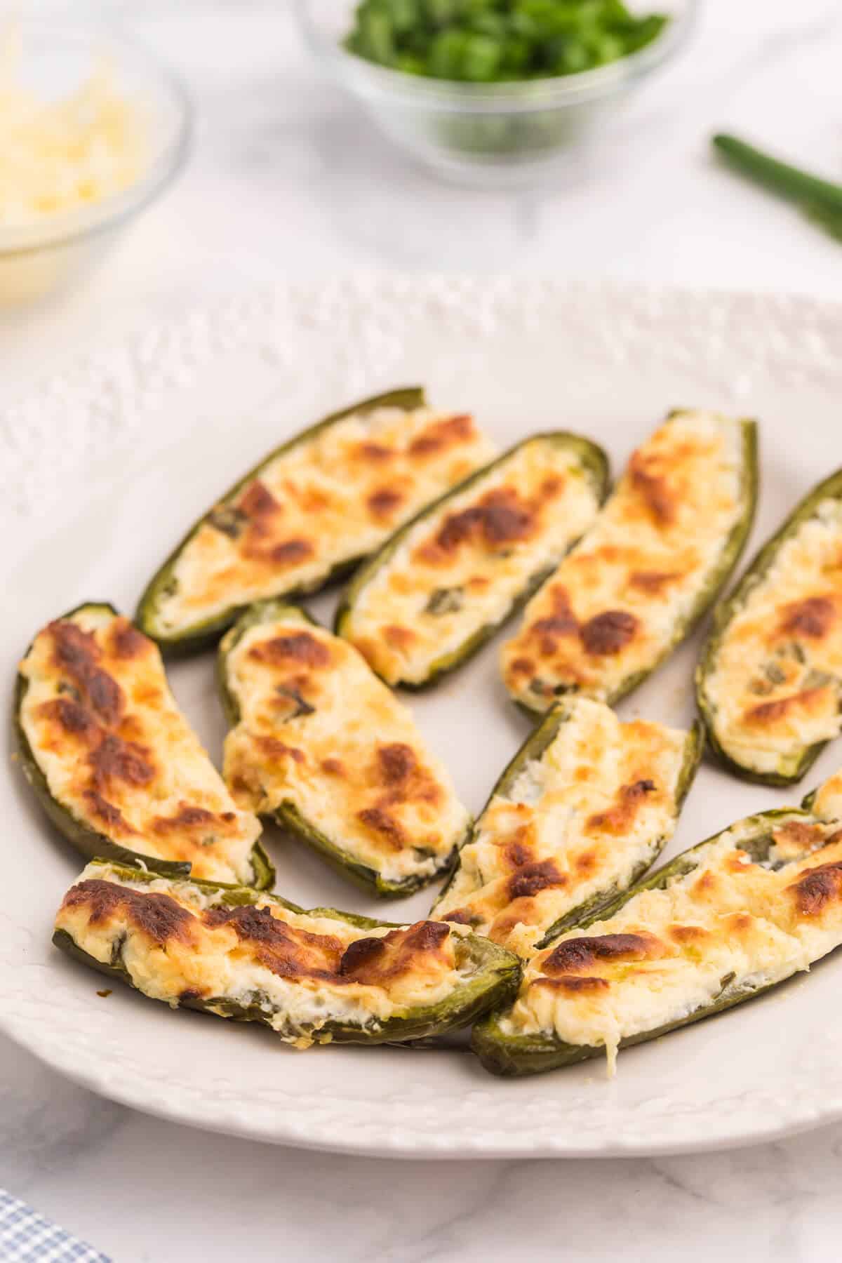 A plate of cheese stuffed jalapenos.