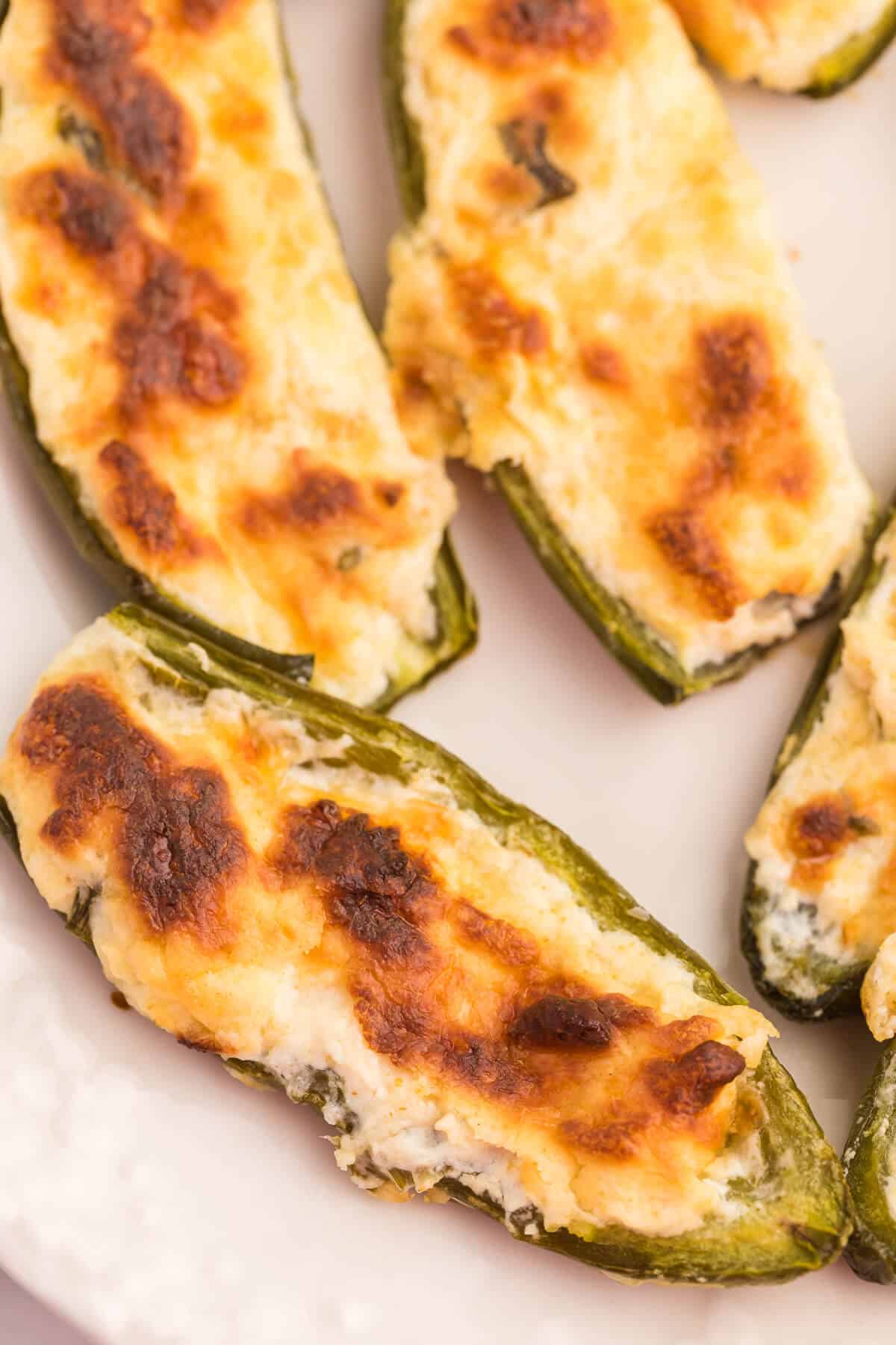 Cheese stuffed jalapenos on a plate.