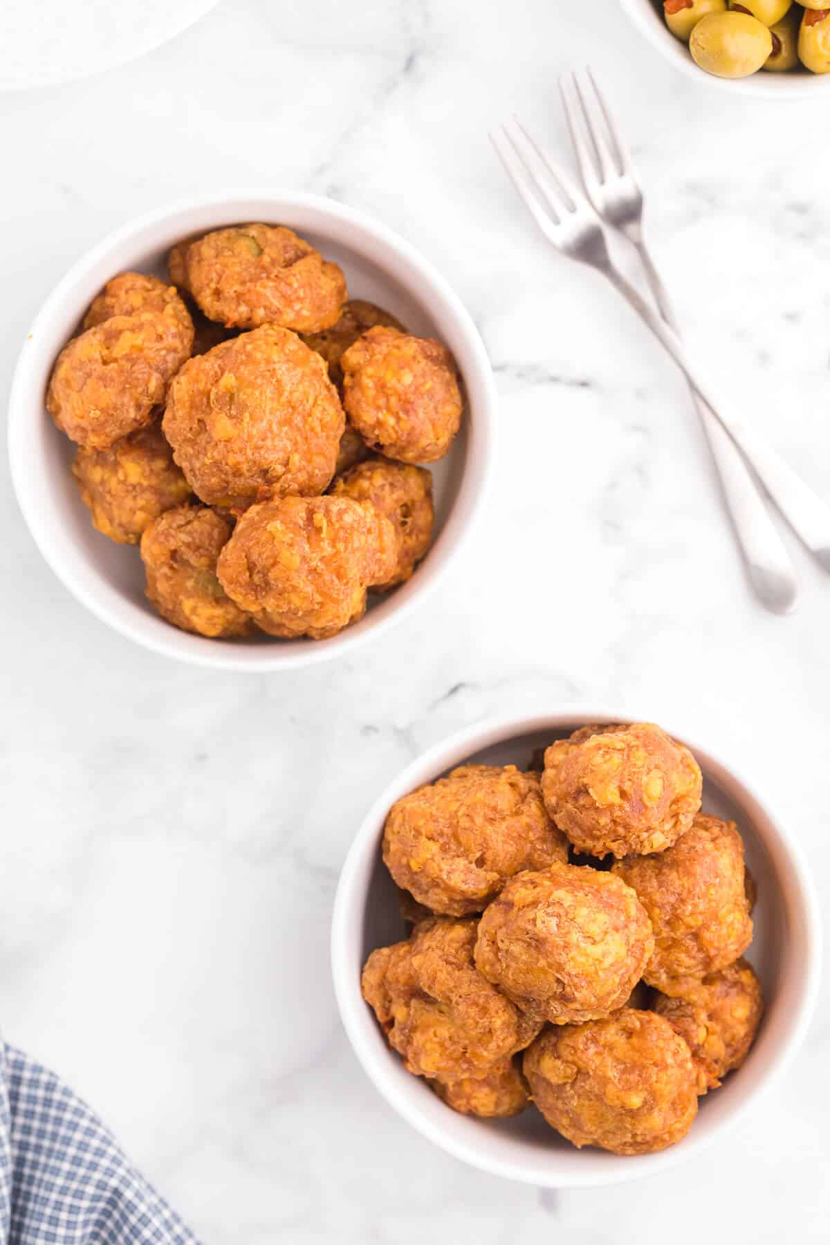 Olive Cheese Balls - A holiday favorite with a vegetarian twist! These perfect hors d'oeuvres are packed with olives, cheese, paprika, Worcestershire sauce, and a pinch of cayenne pepper.