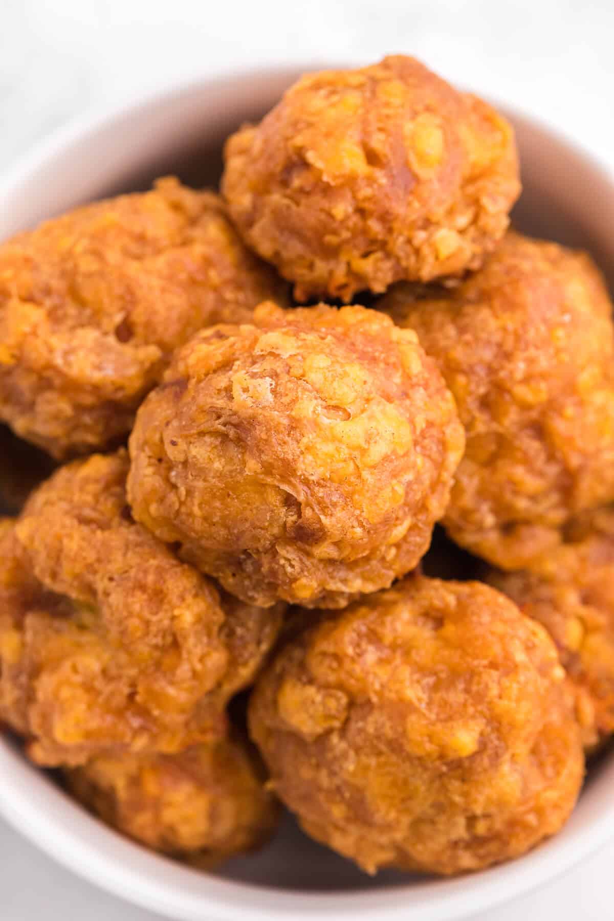 Close up of olive cheese balls in a bowl.