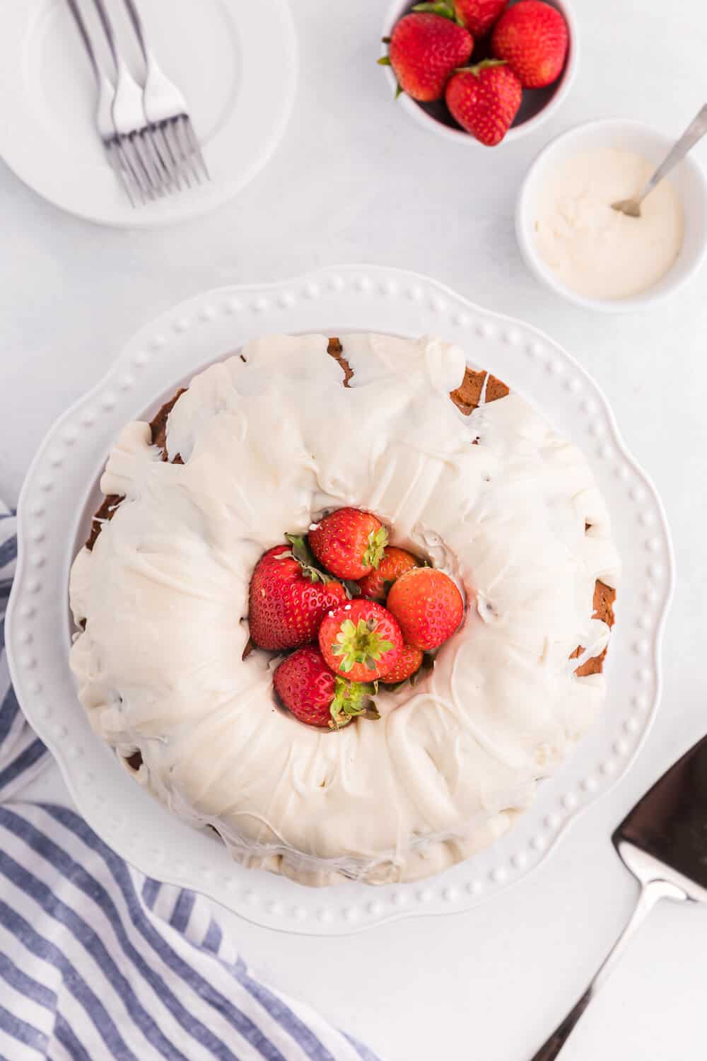 Vanilla Cream Cheese Cake on a a white background with strawberries