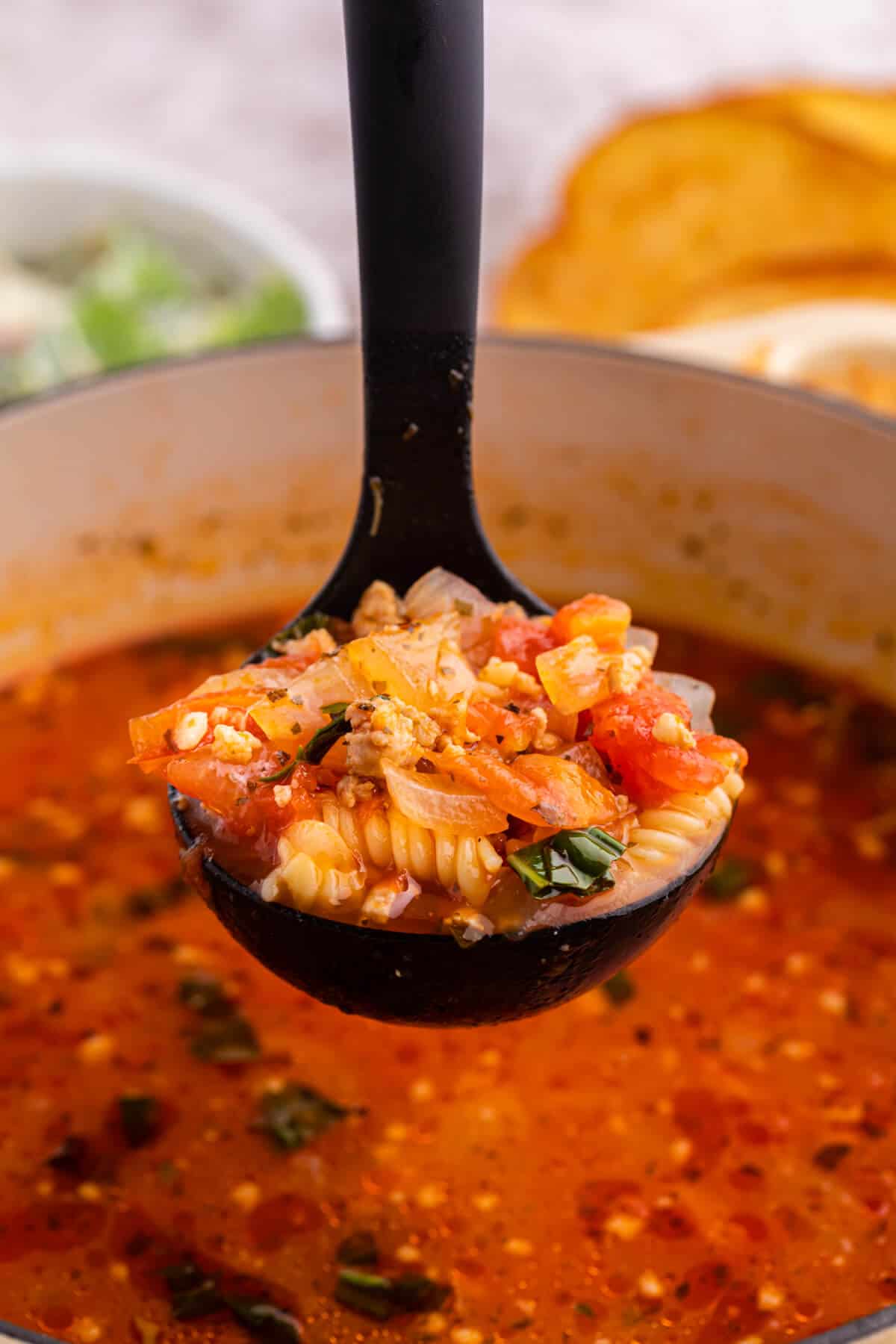 Lasagna soup in a ladle.