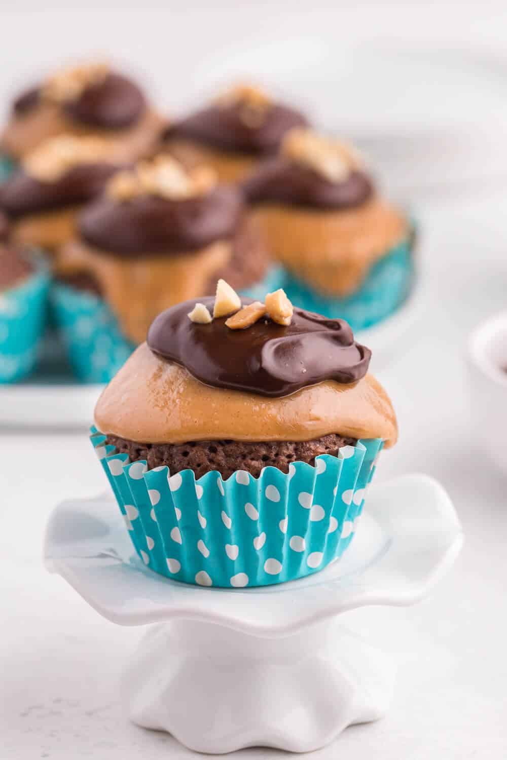 peanut butter brownie cupcake on a cupcake stand