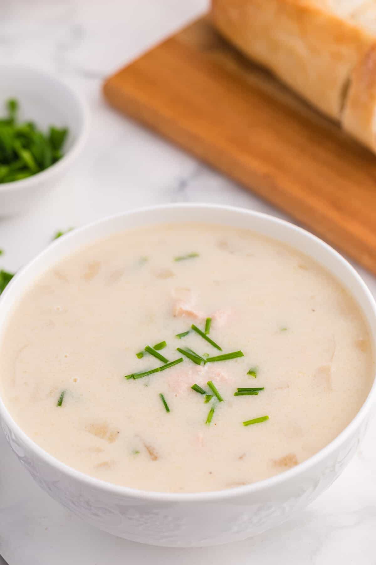 Salmon chowder in a white bowl.