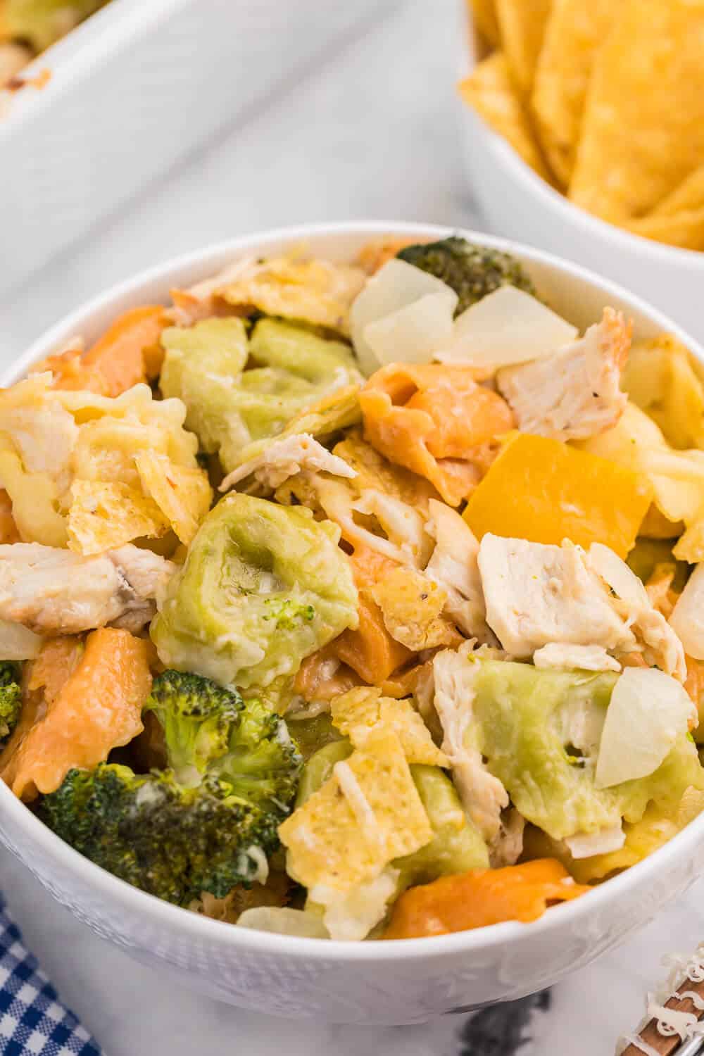 Santa Fe Chicken Tortellini Casserole - Tortellini pasta with veggies and chicken enveloped in a creamy sauce and topped with crunchy tortilla chips. An easy family dinner recipe ready in under 1 hour.