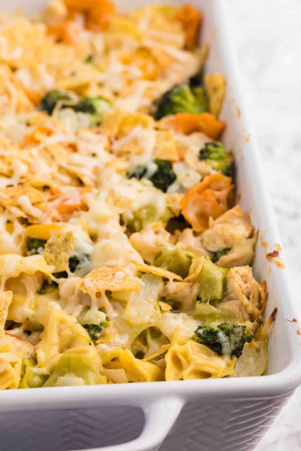 Santa Fe Chicken Tortellini Casserole - Tortellini pasta with veggies and chicken enveloped in a creamy sauce and topped with crunchy tortilla chips. An easy family dinner recipe ready in under 1 hour.