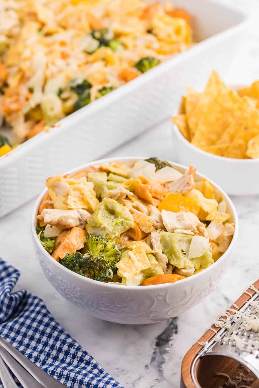 Santa Fe Chicken Tortellini Casserole - Tortellini pasta with veggies and chicken enveloped in a creamy sauce and topped with crunchy tortilla chips. An easy family dinner recipe ready in under 1 hour.