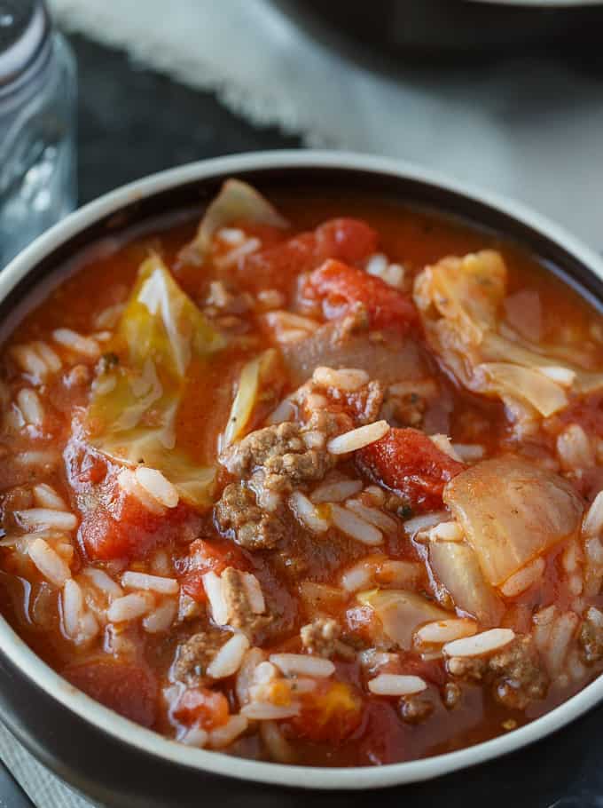 Cabbage Roll Soup - Hearty and comforting! This delicious and easy slow cooker soup recipe is loaded with tender cabbage, ground beef, oregano, garlic, and tomatoes. Everything you love about a cabbage roll, but 100 times easier to make. Yum!