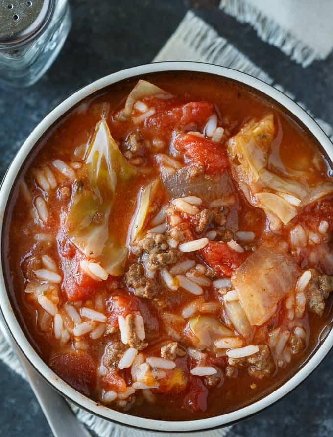 Cabbage Roll Soup - Hearty and comforting! This delicious and easy slow cooker soup recipe is loaded with tender cabbage, ground beef, oregano, garlic, and tomatoes. Everything you love about a cabbage roll, but 100 times easier to make. Yum!