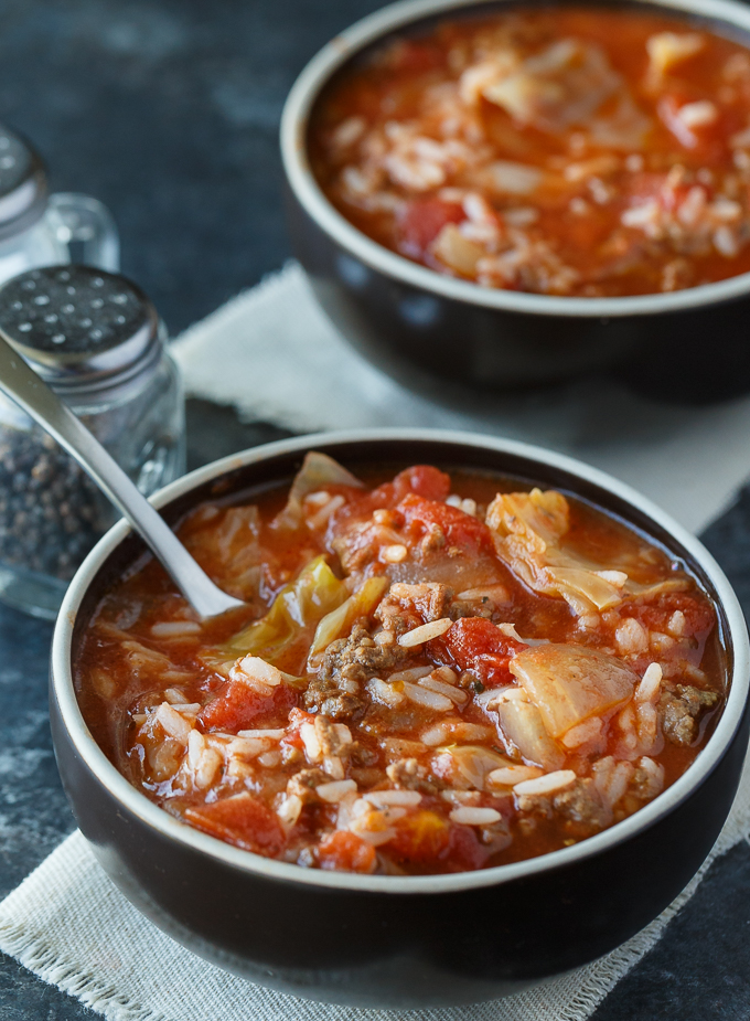 Cabbage Roll Soup - Hearty and comforting! This delicious and easy slow cooker soup recipe is loaded with tender cabbage, ground beef, oregano, garlic, and tomatoes. Everything you love about a cabbage roll, but 100 times easier to make. Yum!