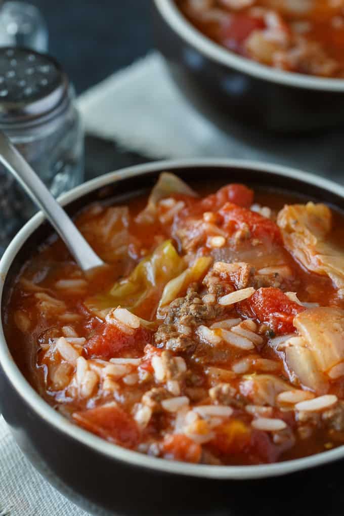 Cabbage Roll Soup - Hearty and comforting! This delicious and easy slow cooker soup recipe is loaded with tender cabbage, ground beef, oregano, garlic, and tomatoes. Everything you love about a cabbage roll, but 100 times easier to make. Yum!