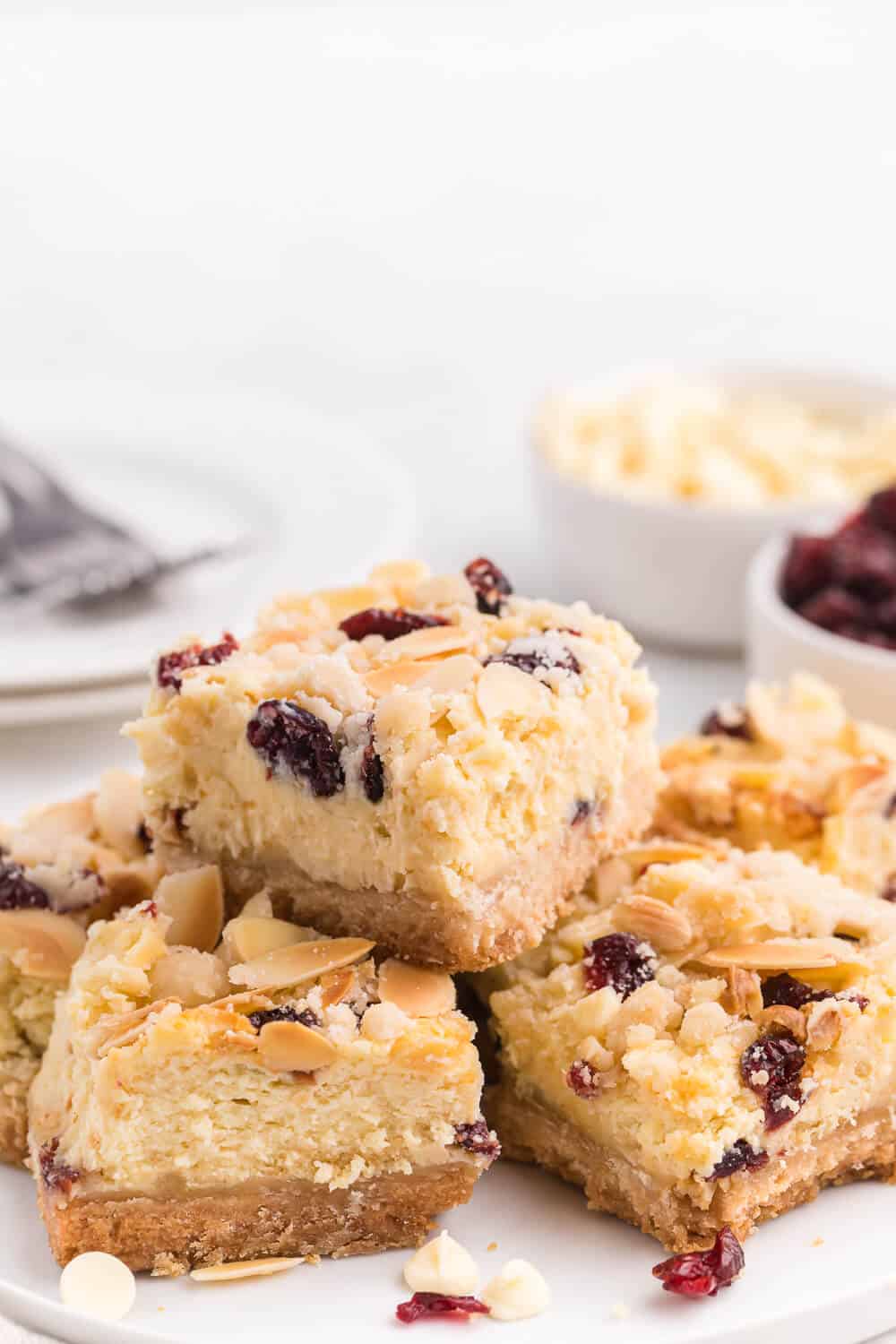 A plate of white chocolate cranberry cheesecake bars