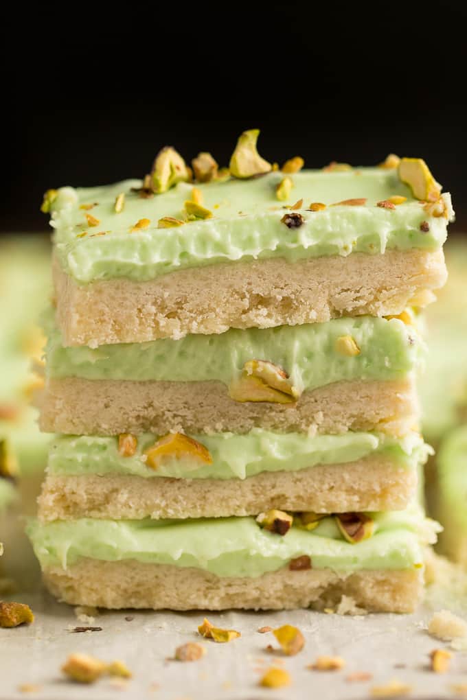 Pistachio Cream Bars - Made with a shortbread cookie base and filling that is a cross between a pudding and cheesecake. This vibrantly coloured dessert is a great make-ahead dish for entertaining. The crowd pleasing flavour of pistachio will be a winner!
