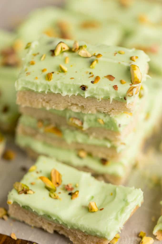 Pistachio Cream Bars - Made with a shortbread cookie base and filling that is a cross between a pudding and cheesecake. This vibrantly coloured dessert is a great make-ahead dish for entertaining. The crowd pleasing flavour of pistachio will be a winner!