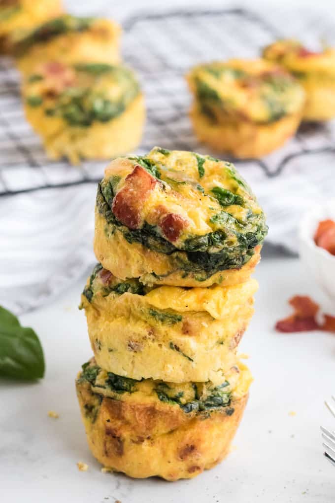 A stack of three spinach and cheese egg muffins.